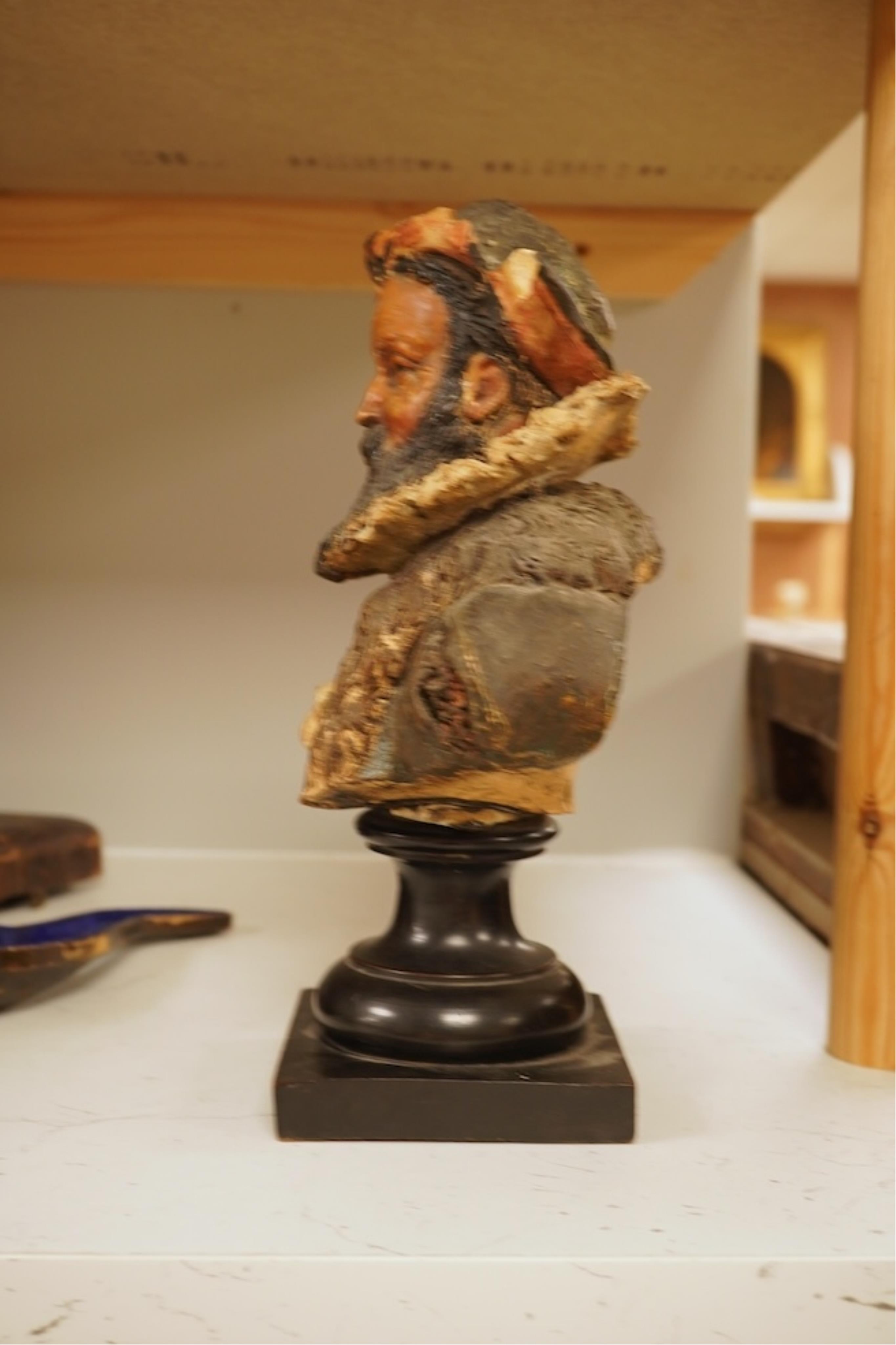 A 19th century German cold-painted terracotta bust, on ebonised socle and a Meerschaum pipe in case, bust 27cm high